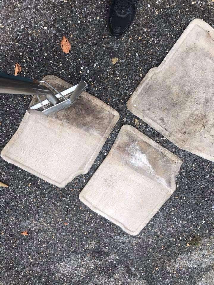 Car floor mats being steam cleaned